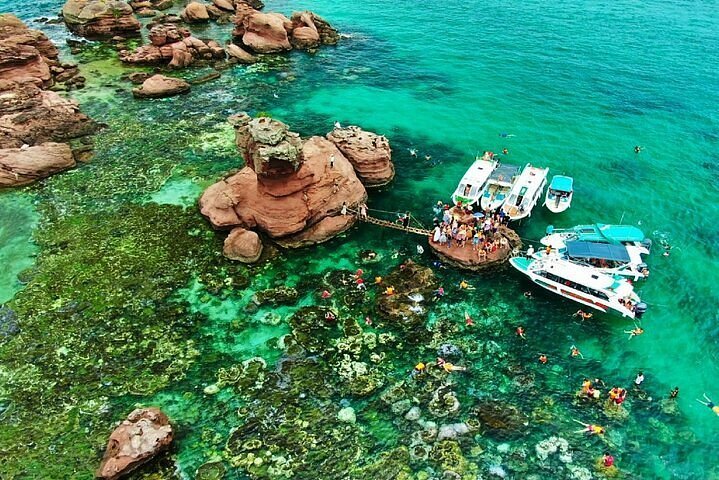 A wooden boat over clear water among the An Thoi islands off southern Phu Quoc in the morning