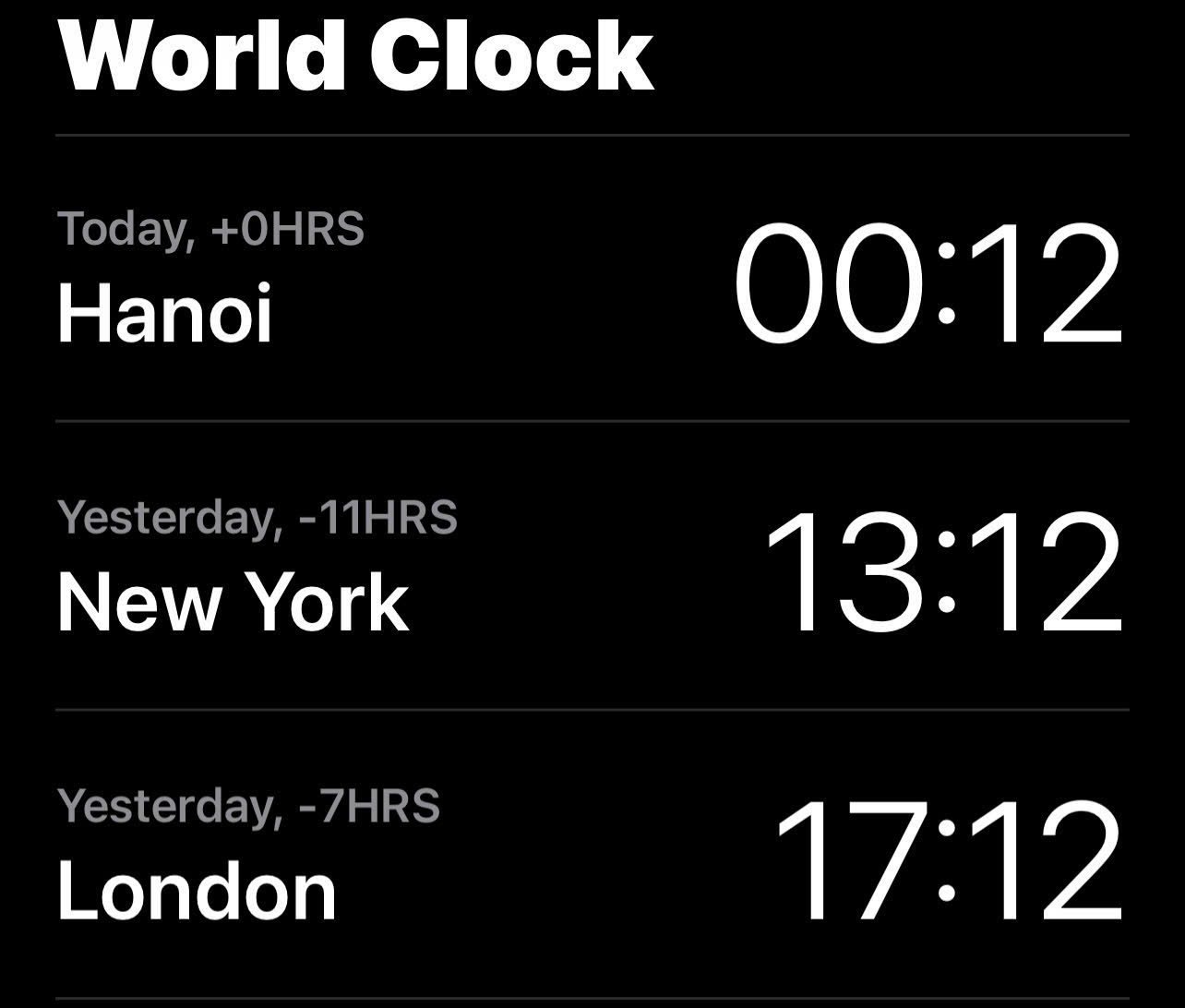 Phone world clock showing Hanoi 00:12, New York 13:12 the day before, and London 17:12